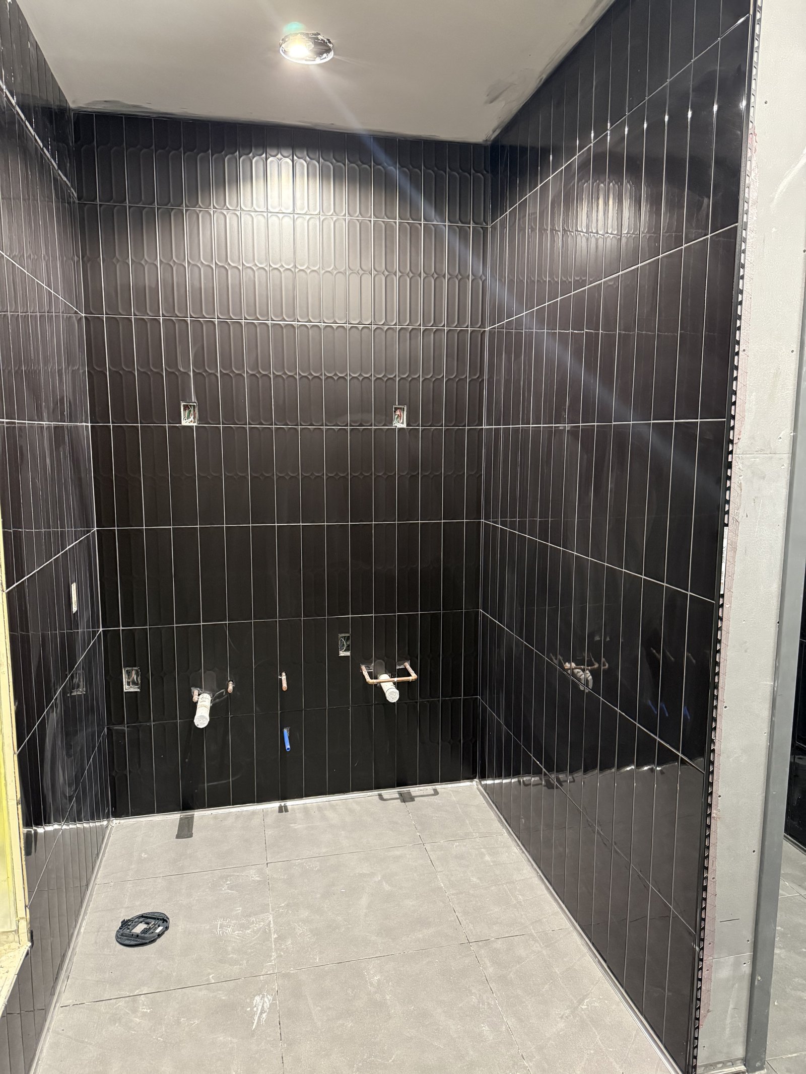 Black tile shower installation with sleek modern design